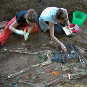 Forensic anthropologists uncovering human remains