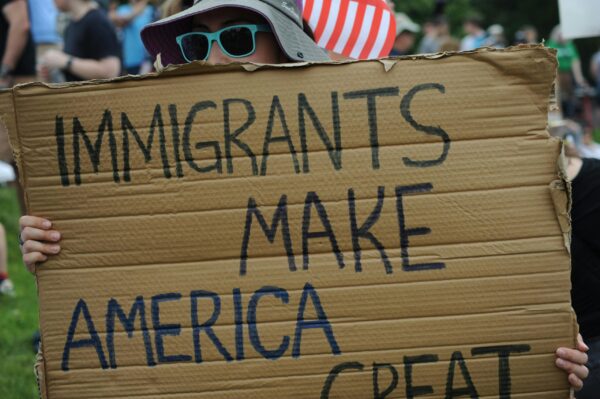 Protestor holding sign "Immigrants make America great"